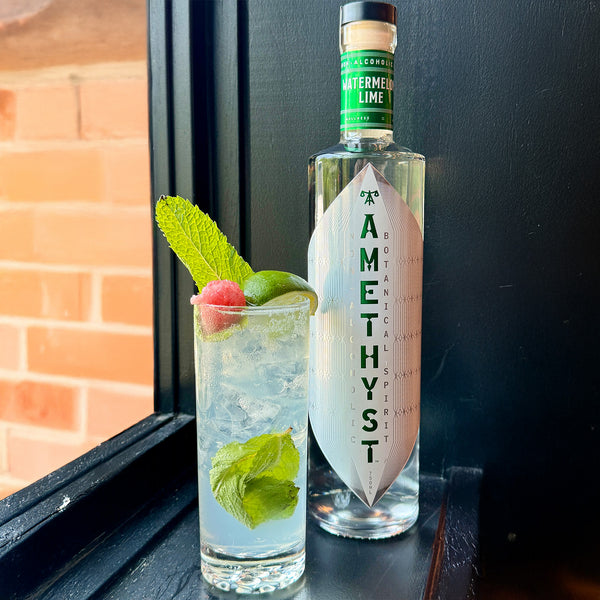 Amethyst Watermelon Lime served in a glass with ice and lime, perfect for non-alcoholic cocktails.